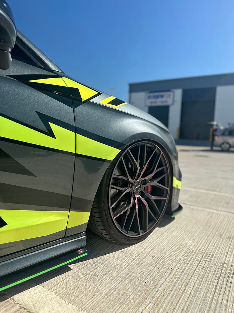 Stuart Hammond’s 2016 Audi A3 S line Sportback 2.0L TDI, with a custom wrap of acid yellow, black, and white decals created by Wraptor Customs